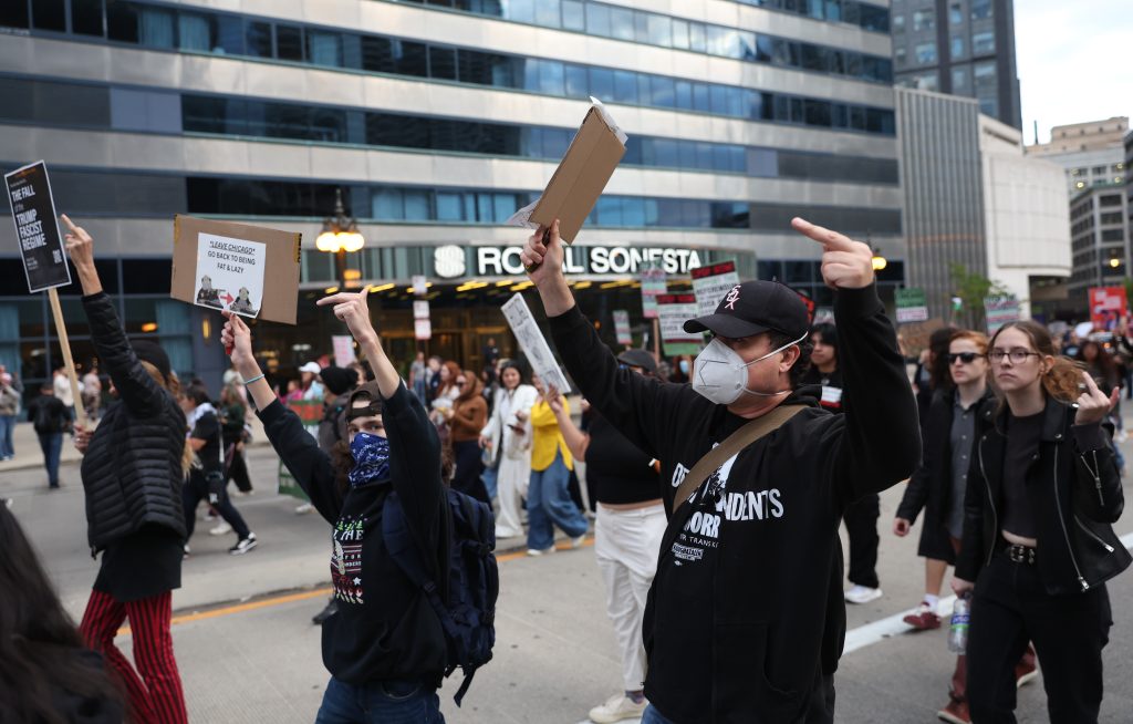 Protesters flip off Trump Tower during a protest against immigration raids in Chicago on Saturday, Sept. 6, 2025.