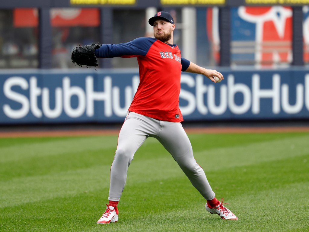 Boston Red Sox pitcher Garrett Crochet throwing a baseball during a practice.