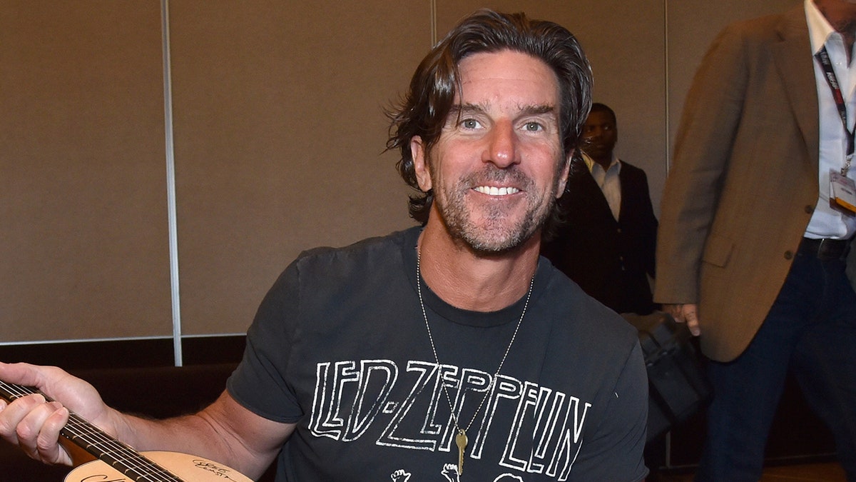 Brett James holding a guitar
