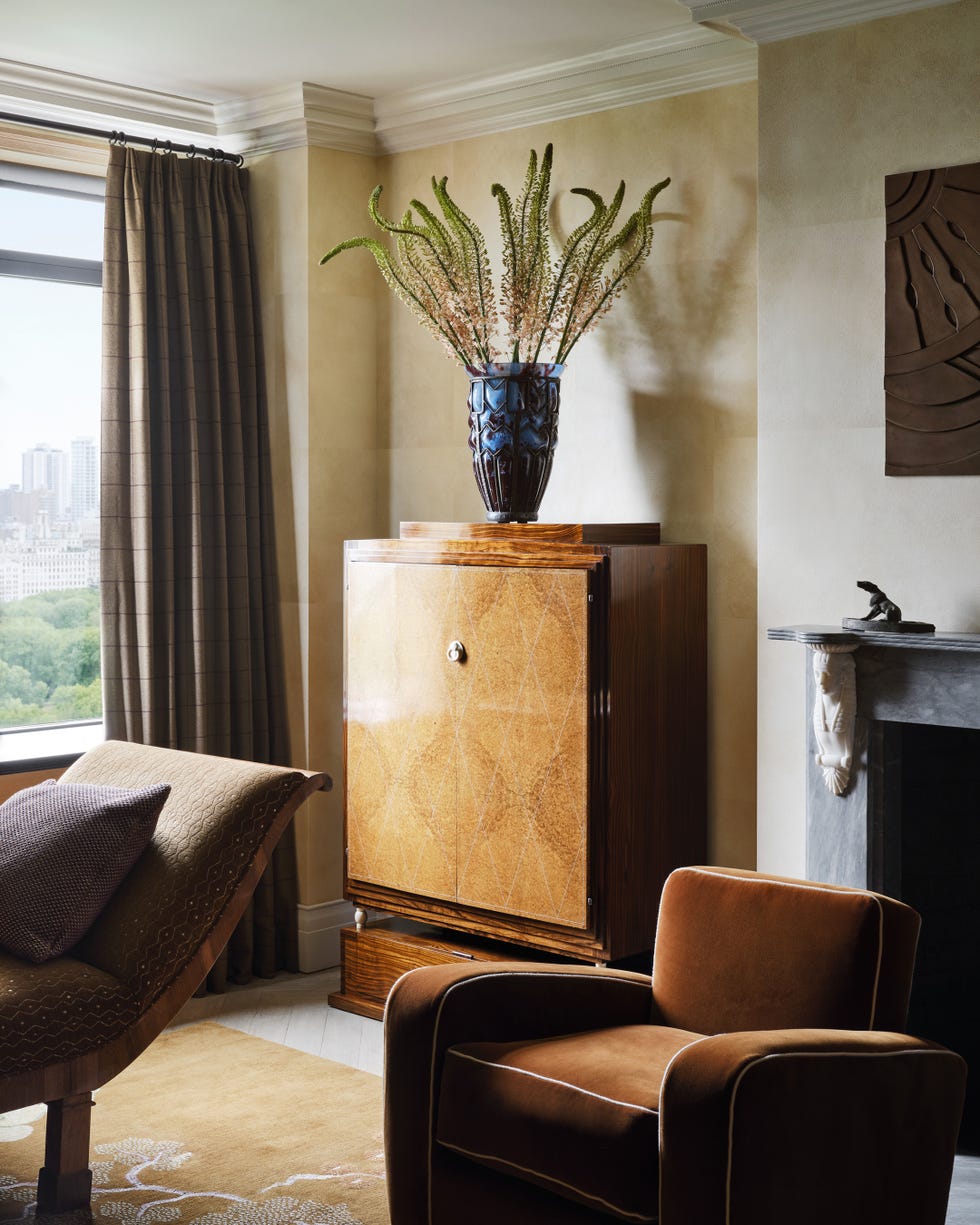 Stylish living room arrangement with art deco furniture and floral decor.