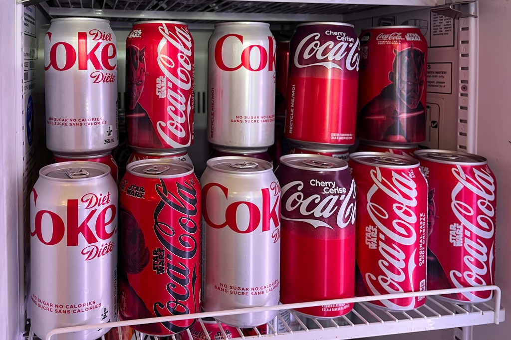 Coca-Cola cans in a refrigerator.