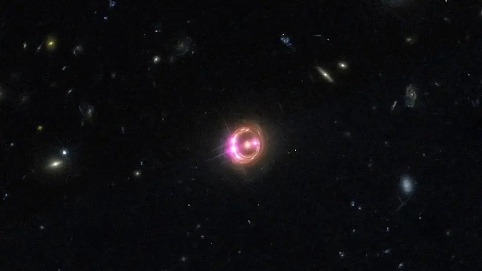  An image of a glowing orange and purple halo in outer space. 