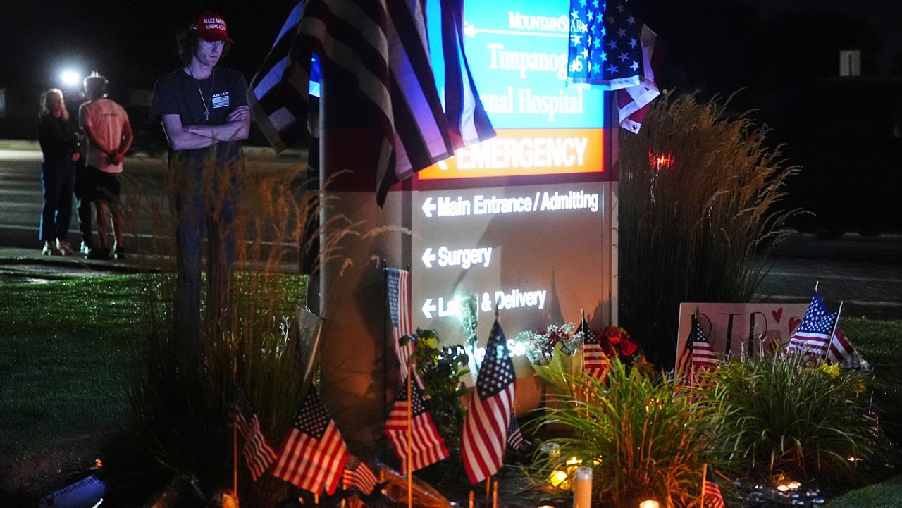 Ammon Paxton, a supporter of Charlie Kirk who witnessed the event as Kirk was shot and killed, visits a growing memorial outside Timpanogos Regional Hospital, Wednesday, Sept. 10, 2025, in Orem, Utah. (AP Photo/Lindsey Wasson)