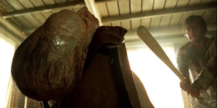 A survivor aims a baseball bat at a Hills Have Eyes mutant 