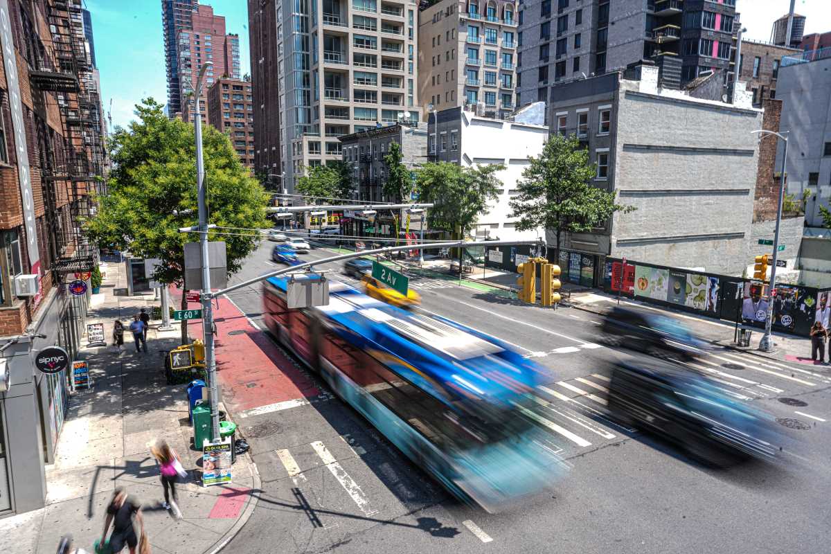 A bus speeds past a congestion pricing gantry in Midtown Manhattan. 