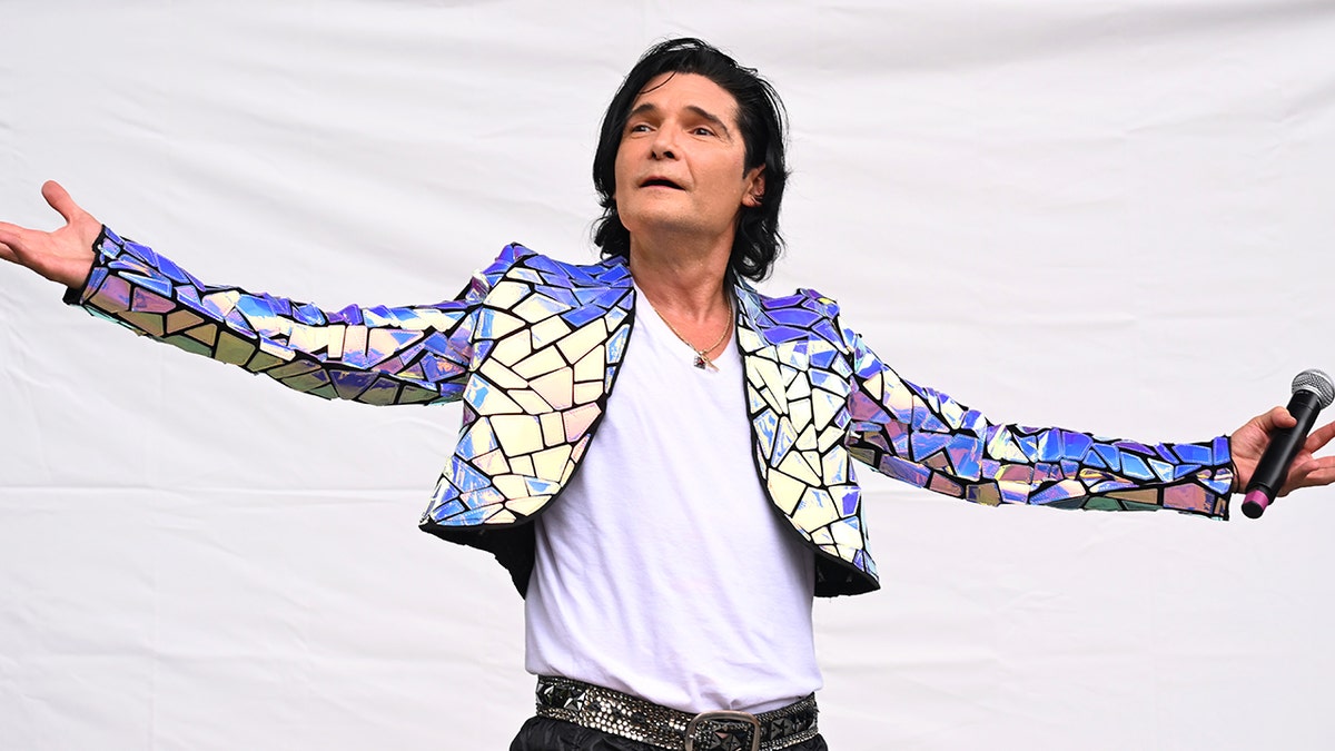 Corey Feldman with his arms outstretched in 2023. 