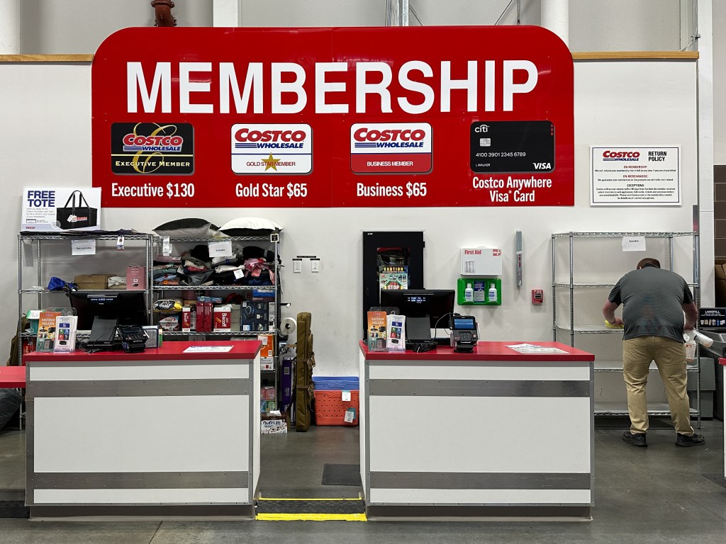 Costco membership counter with pricing information.
