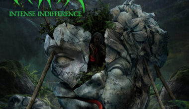 Album cover for Vittra’s Intense Indifference, self-released September 19th, 2025. The artwork depicts a massive cracked stone head lying in a dark, misty forest. The face is split open, propped up by wooden beams, with ferns and plants growing out of the fractures. A shadowy figure with glowing eyes peers from inside the hollow, wearing a red scarf. At the bottom, a bright red snake slithers across mossy rocks near scattered bones and skulls.