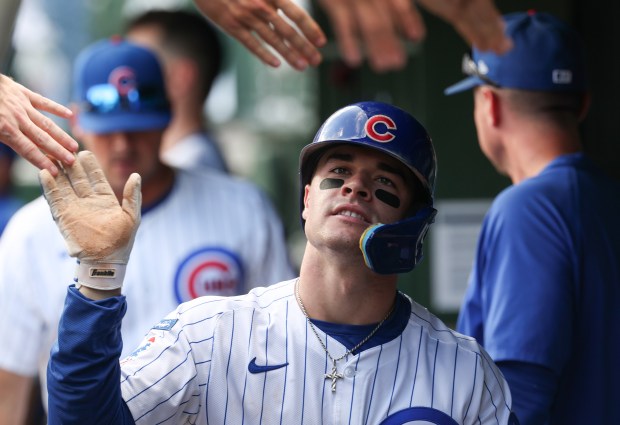 Cubs third baseman Matt Shaw is congratulated after scoring off a triple from first baseman Michael Busch in the seventh inning against the Cardinals at Wrigley Field on Sept. 27, 2025, in Chicago. (John J. Kim/Chicago Tribune)