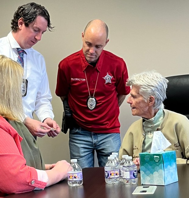 Elgin Detectives Andrew Houghton, left, and Matt Vartanian present items...