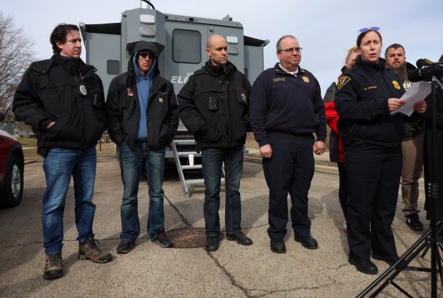 Elgin police Chief Ana Lalley, right, speaks to reporters during...