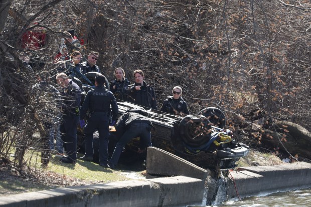Elgin police and fire personnel surround the Toyota Celica of...