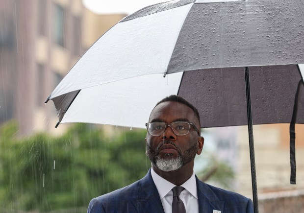 Mayor Brandon Johnson answers questions in the rain, Sept. 23, 2025, during an event in Chicago's West Town neighborhood to mark progress on building bikeways across the city. (Brian Cassella/Chicago Tribune)