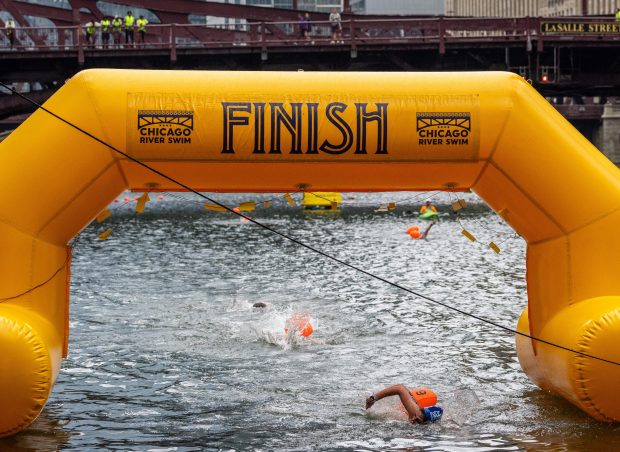 Becca Mann, of Homer Glen, crosses the finish line during the Chicago River Swim on Sept. 21, 2025. Mann placed first in the female no-wetsuit 2-mile division and held the fastest time for the 2-mile division. (Dominic Di Palermo/Chicago Tribune)