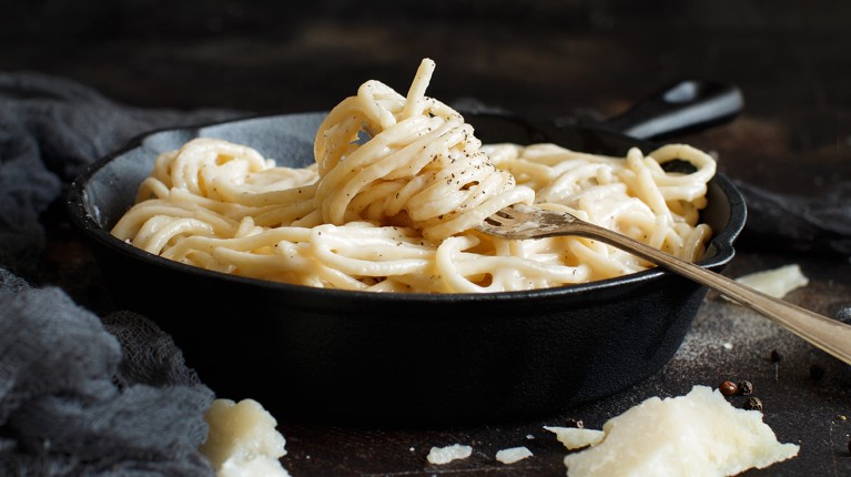 A dish of Cacio e pepe, the Italian cheese and pepper pasta, close up.