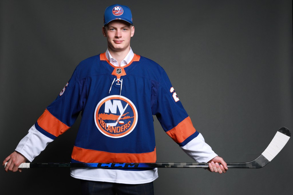 Daniil Prokhorov in New York Islanders jersey holding hockey stick.