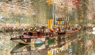 a large-scale installation by Song Dong in the shape of a boat within a fully reflective room, using found wooden window frames, color-coated glass, lamps, furniture, and other knick-knacks