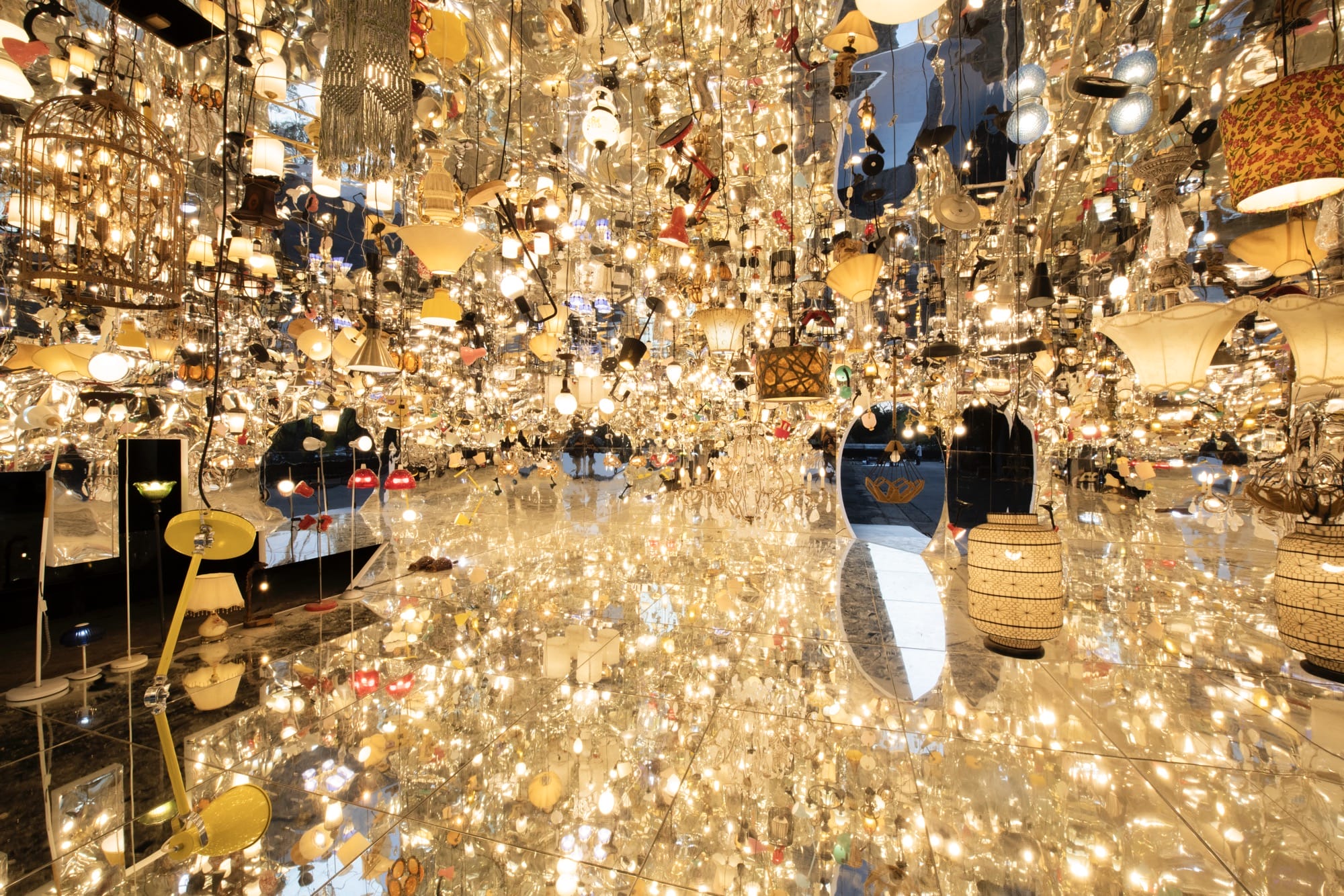 an installation by Song Dong made from borrowed furniture, lamps, and reflective surfaces