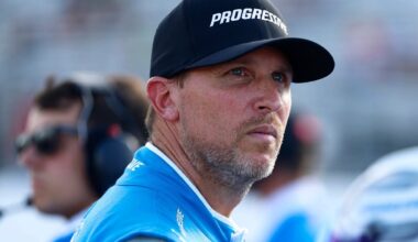 An image of NASCAR driver Denny Hamlin frowning and looking into the distance