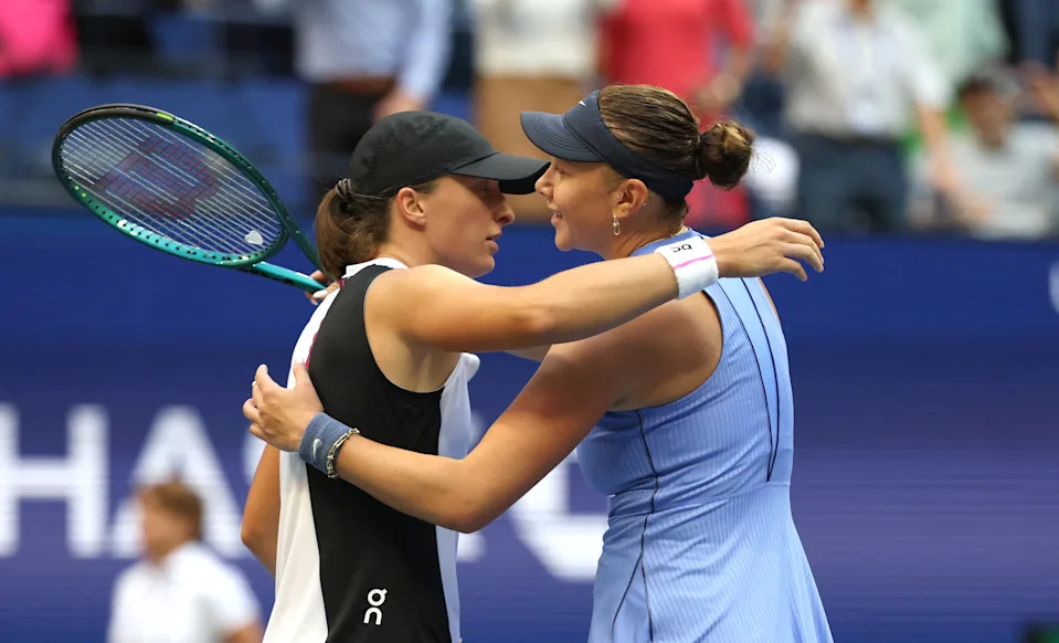 USA's Amanda Anisimova (R) and Poland's Iga Swiatek hug after Anisimova won their women's singles quarterfinal tennis match on day eleven of the US Open tennis tournament at the USTA Billie Jean King National Tennis Center in New York City on September 3, 2025. (Photo by TIMOTHY A. CLARY / AFP) (Photo by TIMOTHY A. CLARY/AFP via Getty Images)          
