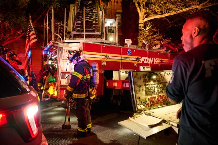 firefighters, with their truck, at the scene of a fire in Brooklyn 