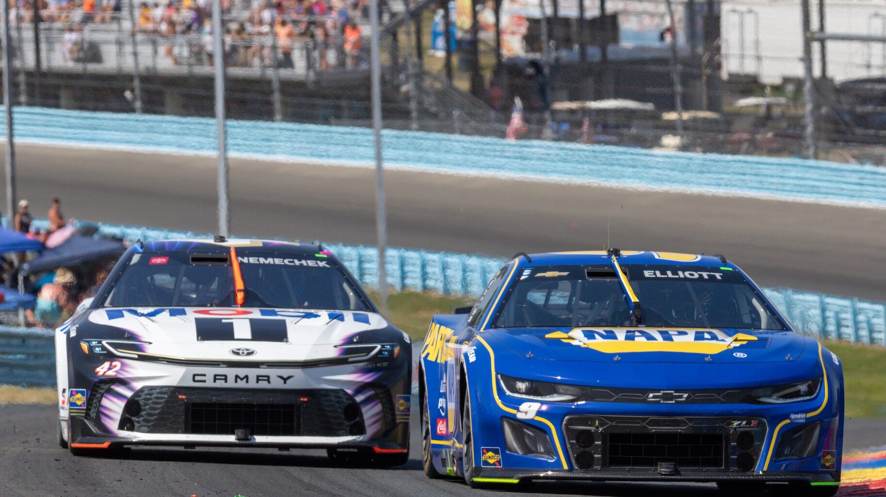 Chase Elliott (#9 Hendrick Motorsports NAPA Auto Parts Chevrolet) gets by John Hunter Nemechek #42 racing up the esses.