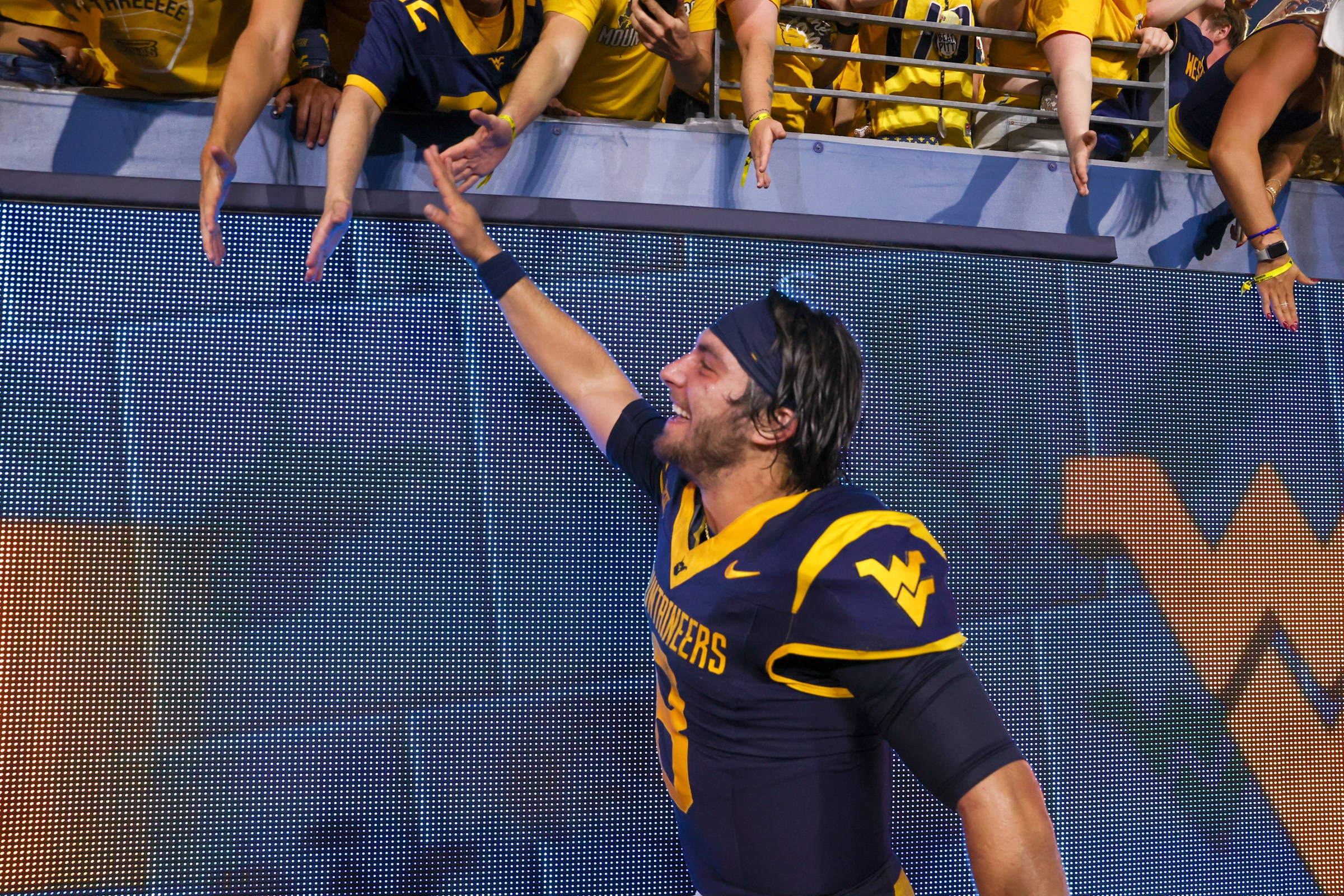 MORGANTOWN, WV - SEPTEMBER 13: West Virginia Mountaineers quarterback Nicco Marchiol (8) celebrates with fans following the college football game between the Pittsburgh Panthers and the West Virginia Mountaineers on September 13, 2025, at Mountaineer Field at Milan Puskar Stadium in Morgantown, WV. (Photo by Frank Jansky/Icon Sportswire via Getty Images)