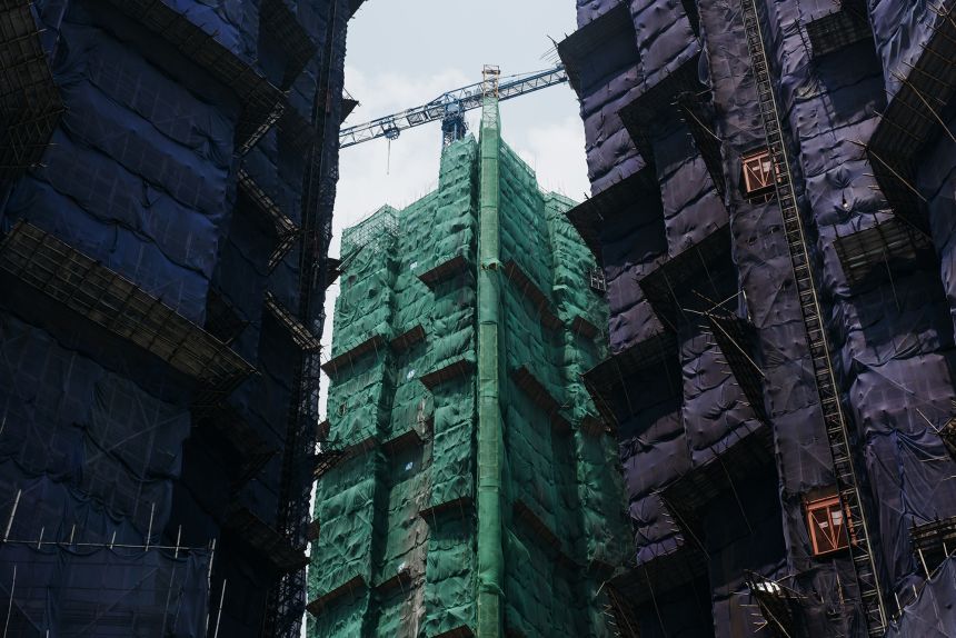 Residential buildings encased with bamboo scaffolding and protective mesh at a site, in Tsuen Wan, Hong Kong on July 30, 2017.