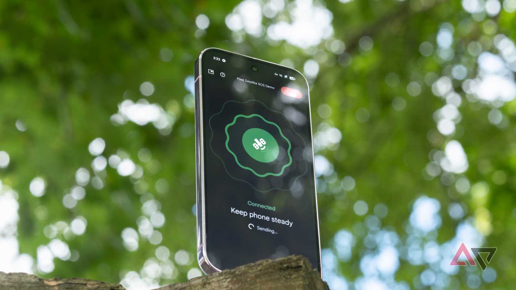 A Google Pixel 9 Pro in an outdoor setting, displaying the Satellite SOS demo