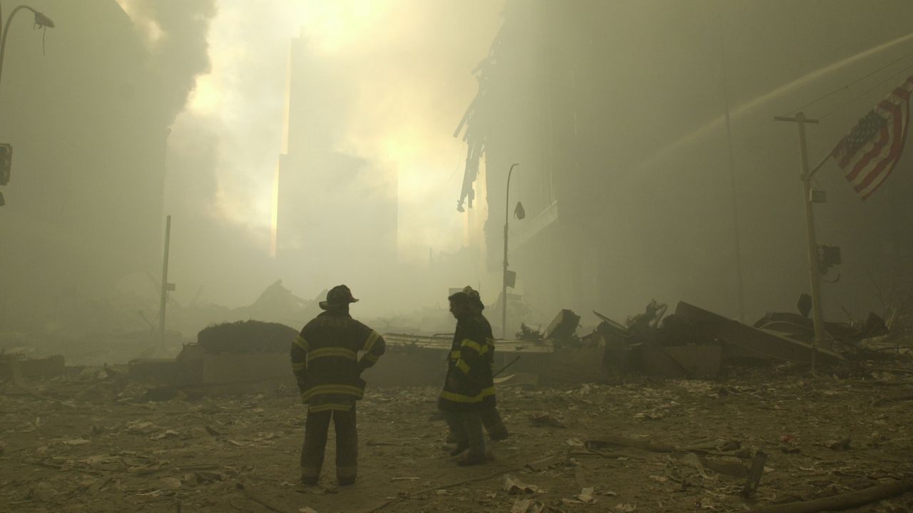 Emergency workers and a flag at ground zero on the evening of Sept. 11, 2001 after the September 11 terrorist attacks on the World Trade Center in New York City.(AP Photo/Mark Lennihan)