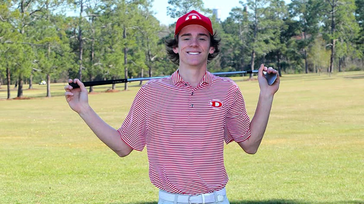 Hadden Kelly poses with golf club