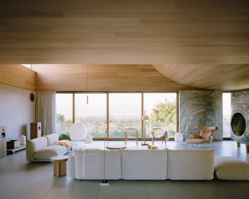 Living room with a curved wood ceiling above the seating area