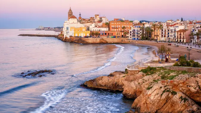 Sand beach and historical Old Town in mediterranean resort Sitges near Barcelona, Costa Dorada, Catalonia, Spain.