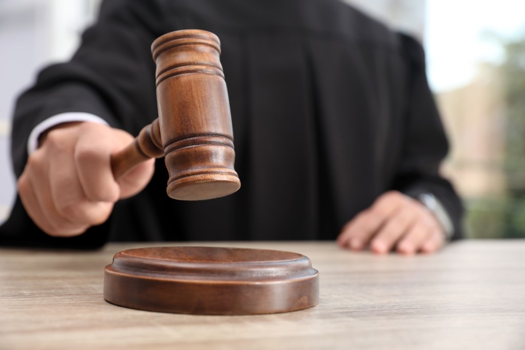 A judge remanded the teacher into custody for now. 