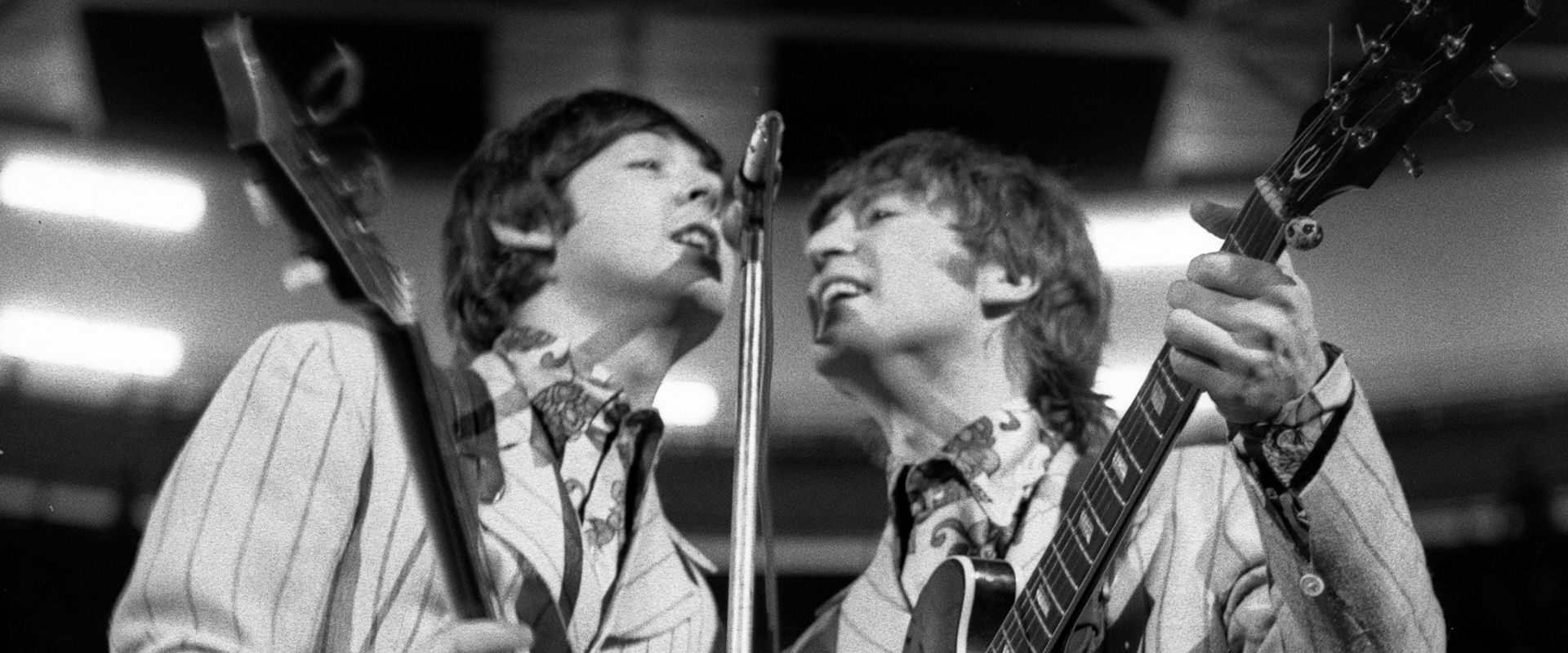Paul McCartney and John Lennon performing