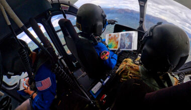 NASA astronauts Matthew Dominick (left) and Mark Vande Hei (right) prepare to fly out to a landing zone in the Rocky Mountains as part of the certification run for the NASA Artemis course at the High-Altitude Army National Guard Aviation Training Site in Gypsum, Colorado, Aug. 26.
