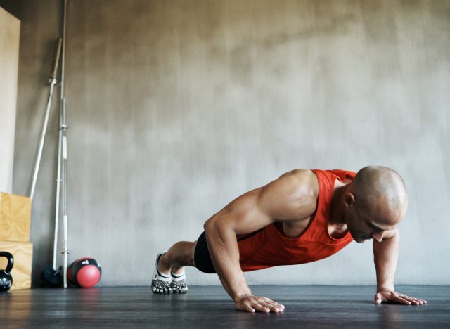 man doing pushups. 2302999075