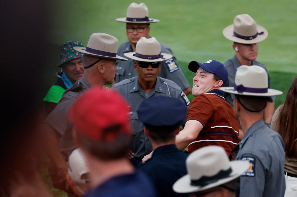Europe's Matt Fitzpatrick celebrates surrounded by New York State Troopers at the Ryder Cup on Sept. 27, 2025.