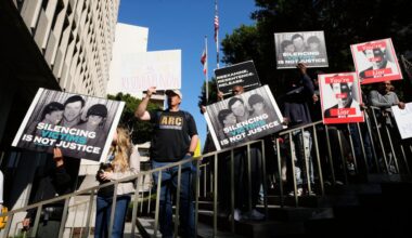 Supporters hold signs during a press conference regarding developments in the Menendez brothers case on Thursday in Los Angeles. (AP Photo/Damian Dovarganes)