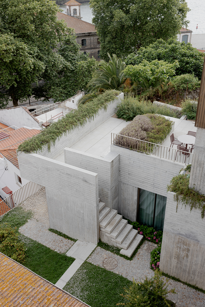 renovated porto residence reimagines hillside terraces with stepped concrete layers