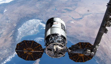 Northrop Grumman's 21st Cygnus cargo craft, with its prominent cymbal-shaped UltraFlex solar arrays, is pictured in the grips of the Canadarm2 robotic arm shortly after its capture on Aug. 6, 2024.