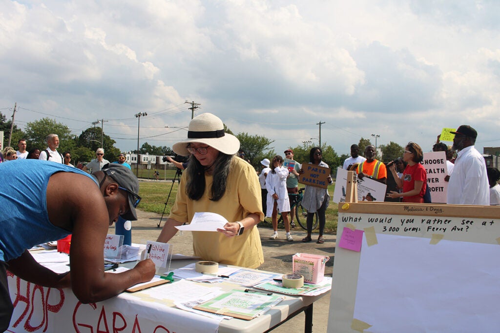 People protest a proposed parking lot