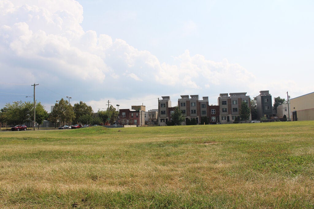 An empty grassy lot in Philadelphia that's the site of a proposed parking lot