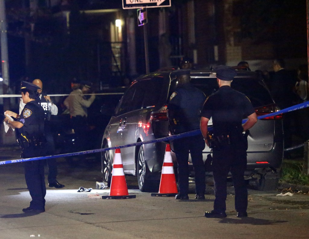 Police investigate a possible homicide scene in Queens, with blue police tape and orange cones visible.