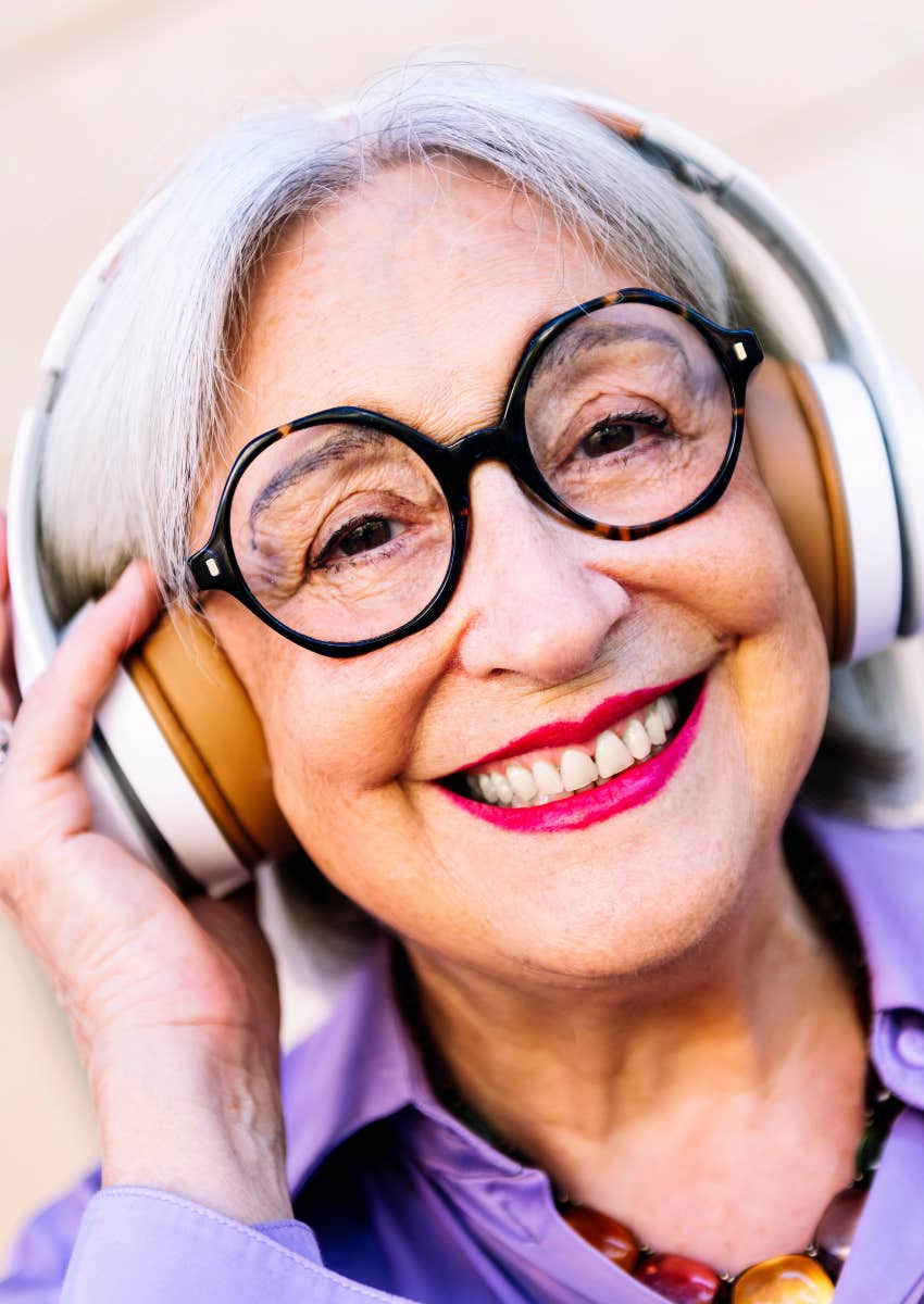 older woman listening to music with headphones