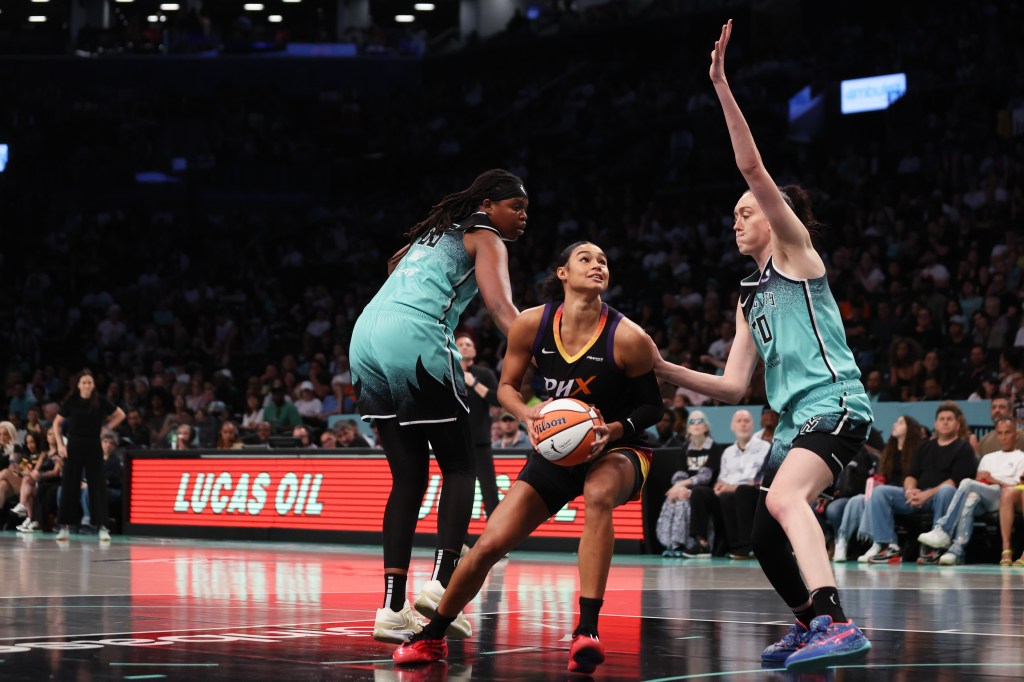 Phoenix Mercury's Satou Sabally dribbling the ball, defended by New York Liberty's Breanna Stewart.