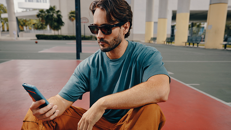 A Ray-Ban Meta smart glasses user staring at his phone