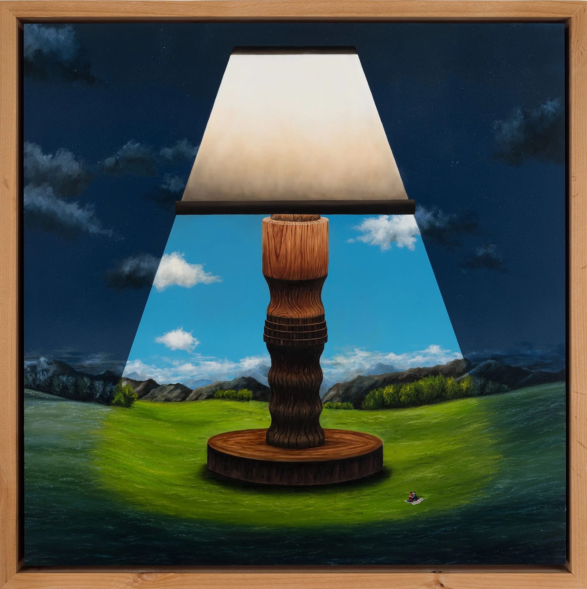 a framed painting by Joseph Renda Jr. of a blue sky and green landscape with a large table lamp lighting up the center