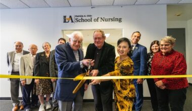 Ribbon-cutting ceremony at the Patricia A. Chin School of Nursing at Cal State LA, with faculty, staff, and supporters gathered under the school’s signage.