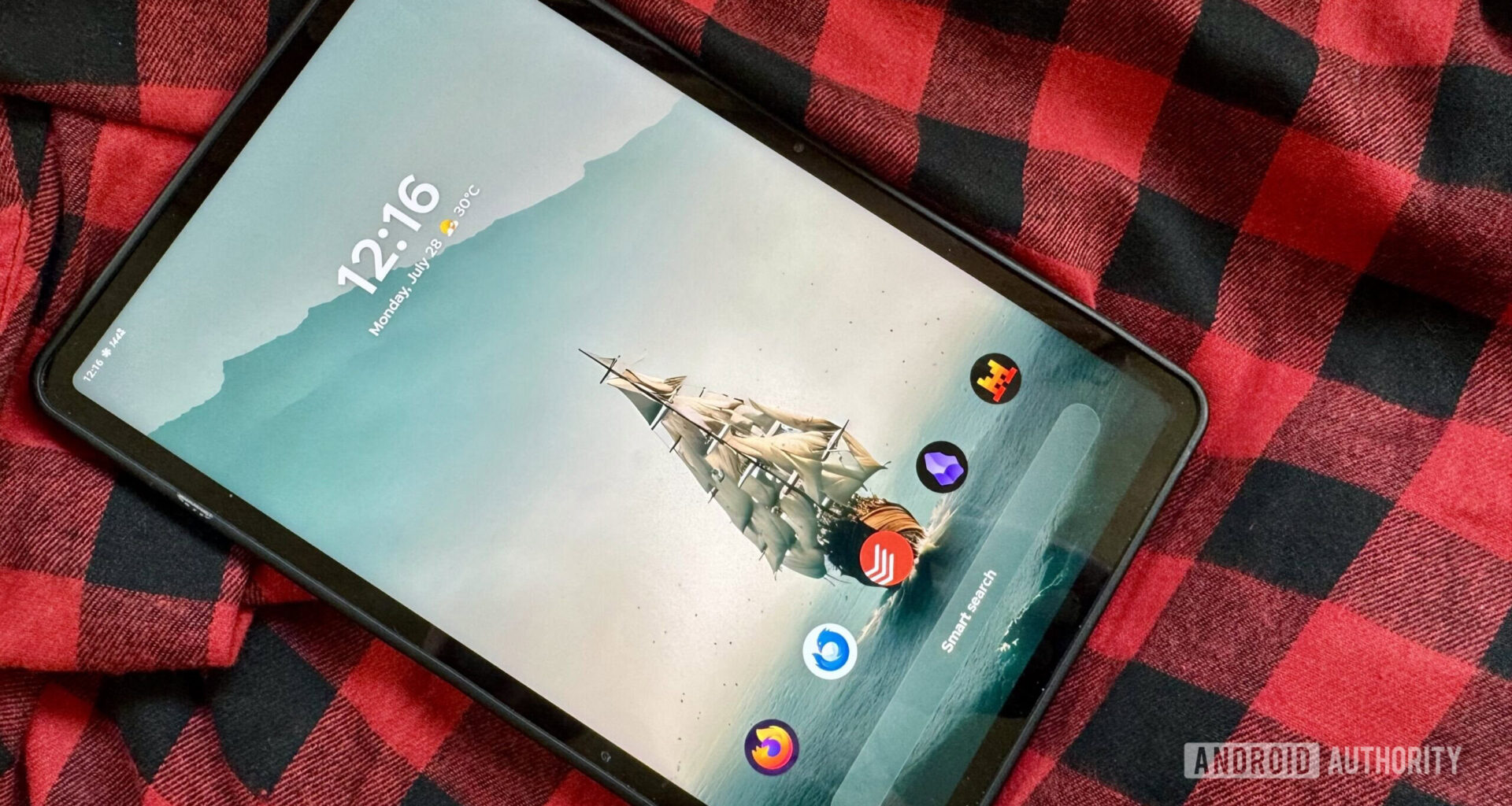 An Android tablet running Smart Launcher 6 on a red and black flannel shirt.
